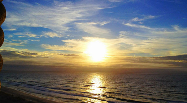 Sunrise on horizon over an ocean or large body of water