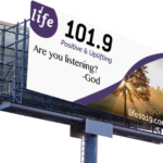 Billboard for life 101.9 radio station with message of are you listing with tree as image on a mockup of a billboard